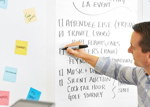 Man at whiteboard with post-it