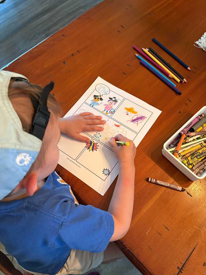 Ollie drawing his comic