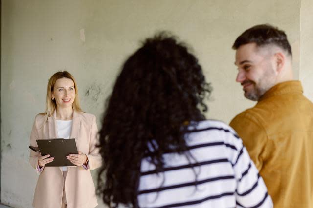 First-time buyers at a viewing with an estate agent