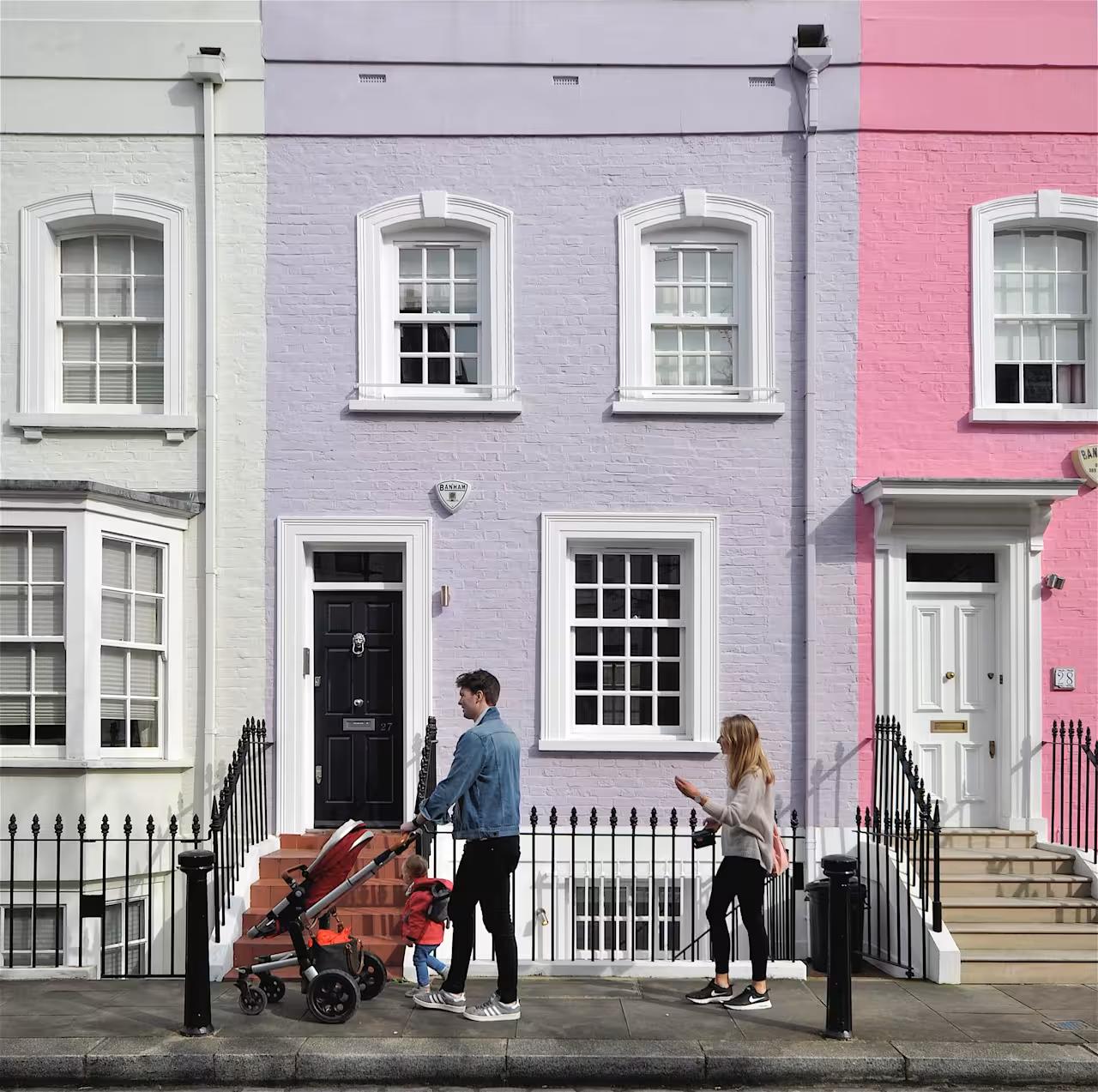 Colourful terraced houses with family walking in front