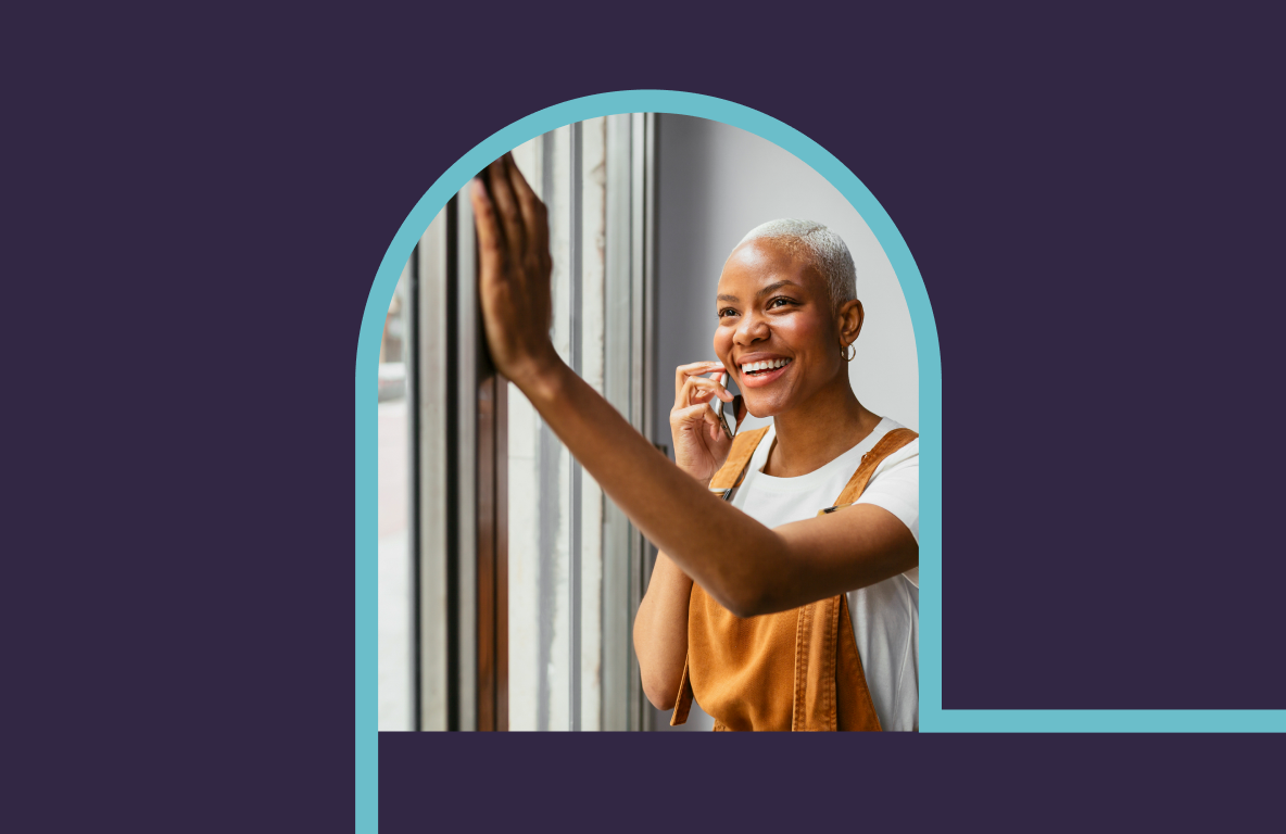 Image of agent on phone with hand on glass window.