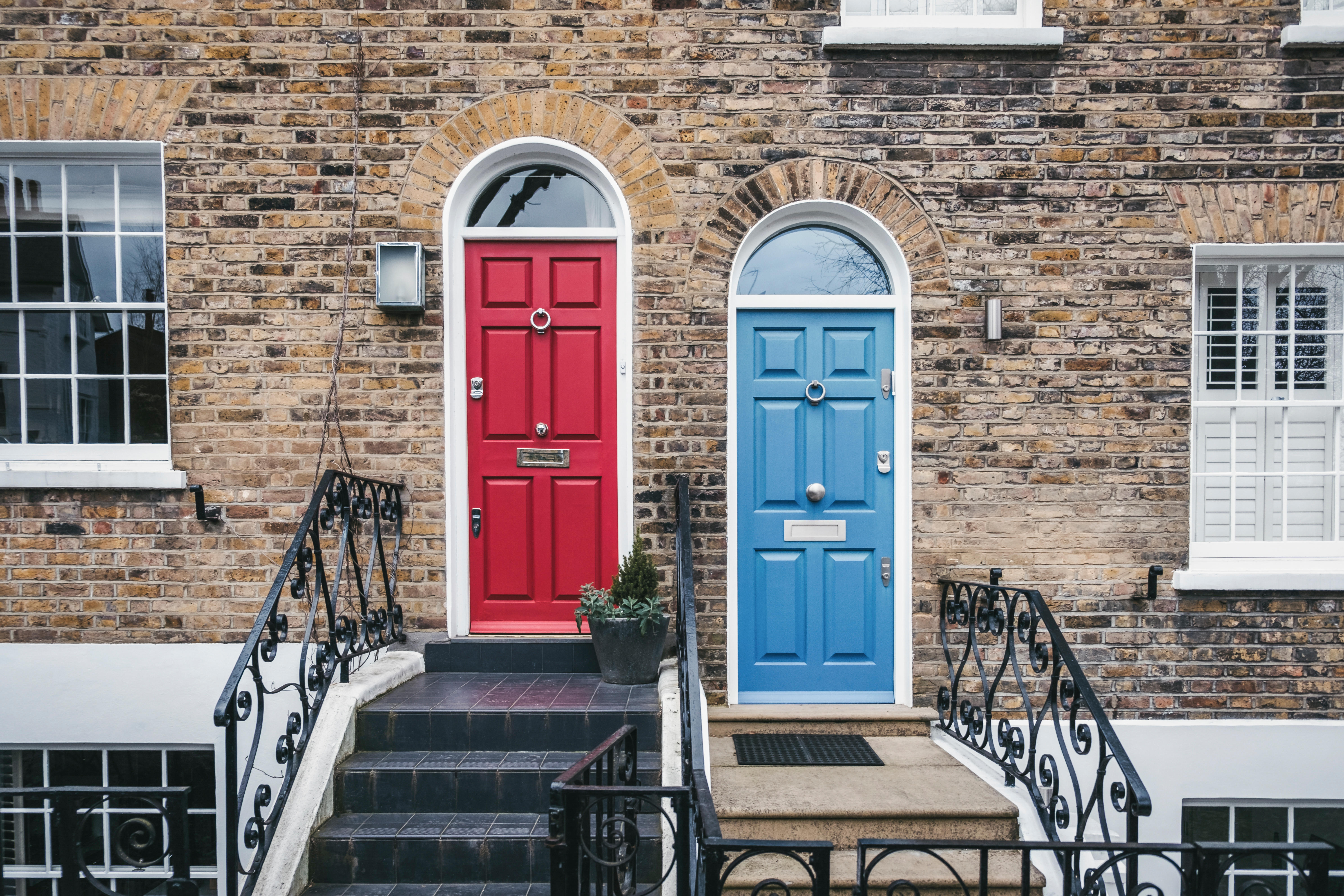 Two terraced houses with different coloured doors.
