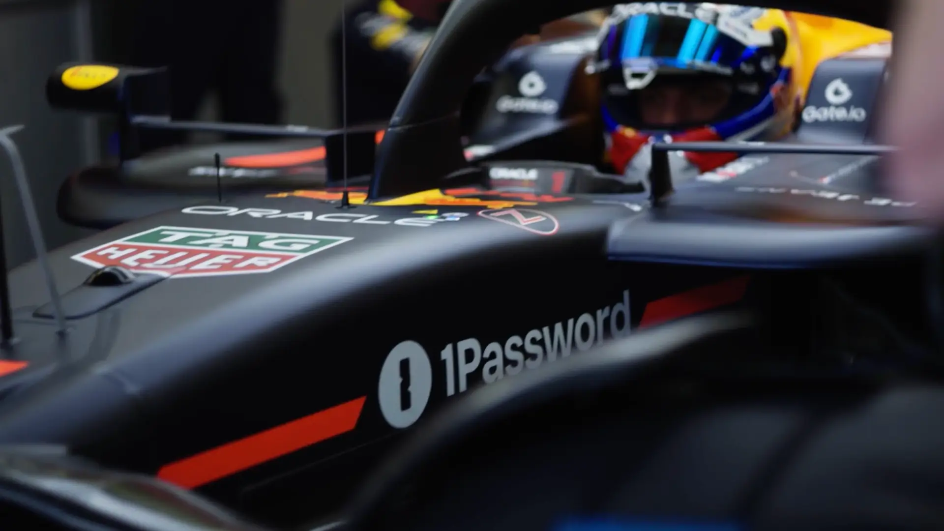 The 1Password logo leads the way on team Oracle Red Bull Racing's competitive vehicles.