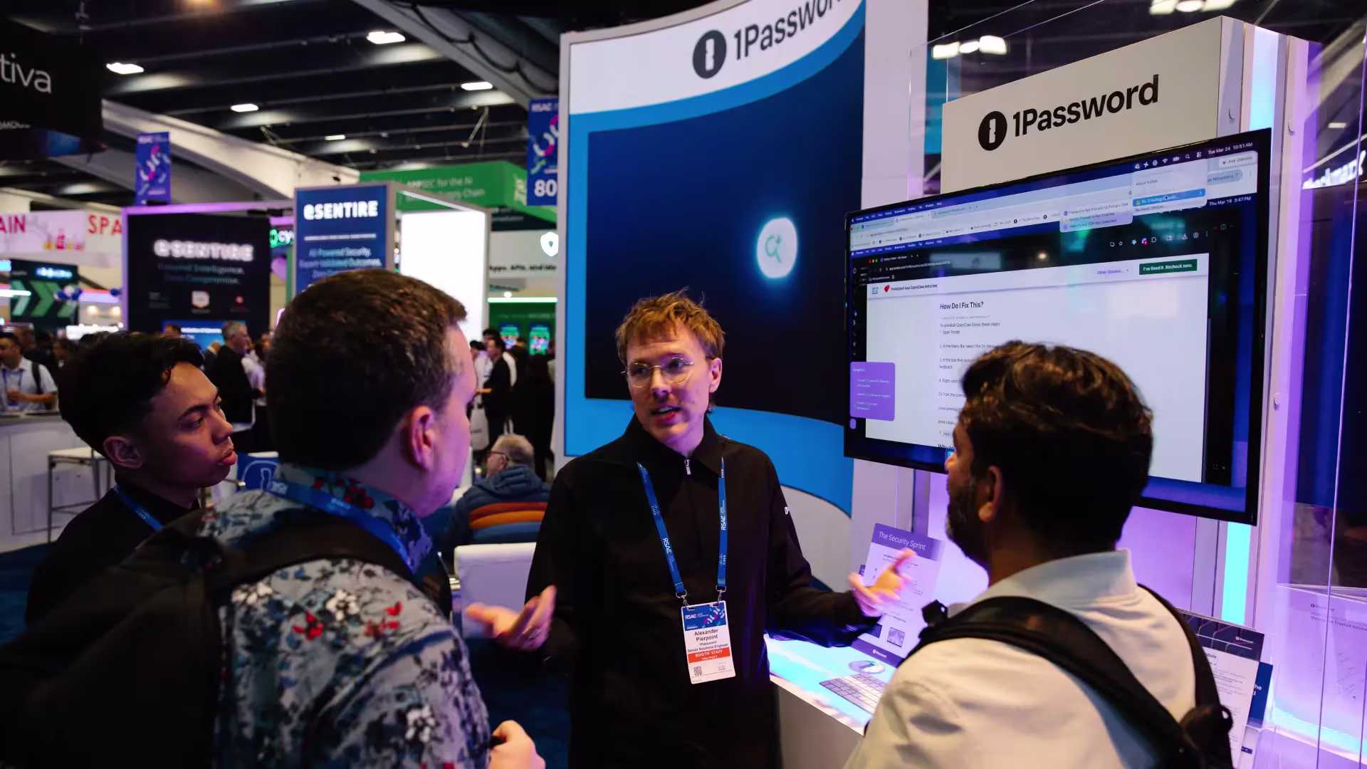 A 1Password representative addresses visitors to the 1Password booth at RSA