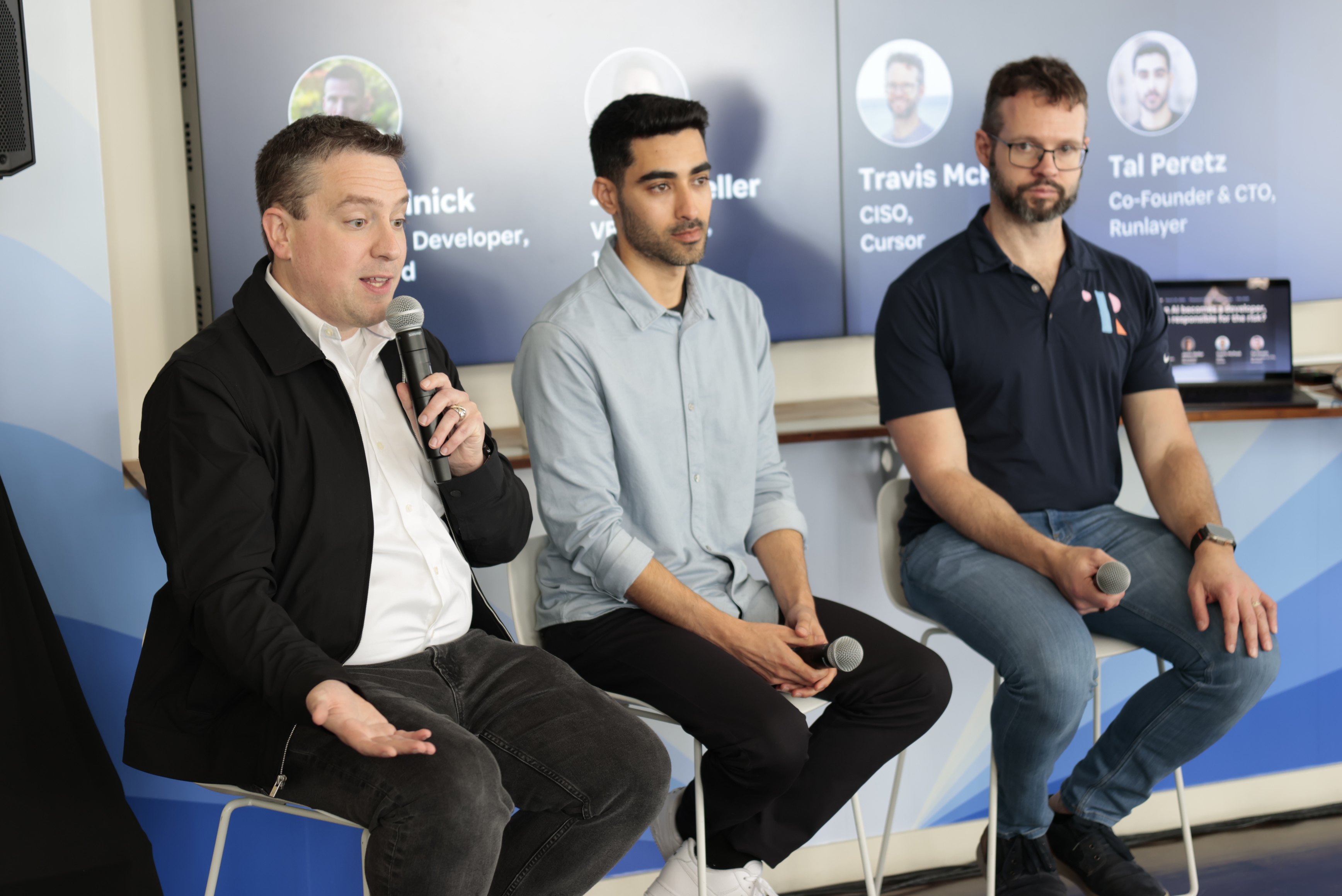 Jason Meller, Tal Peretz, and Travis McPeak talking in a panel discussion.