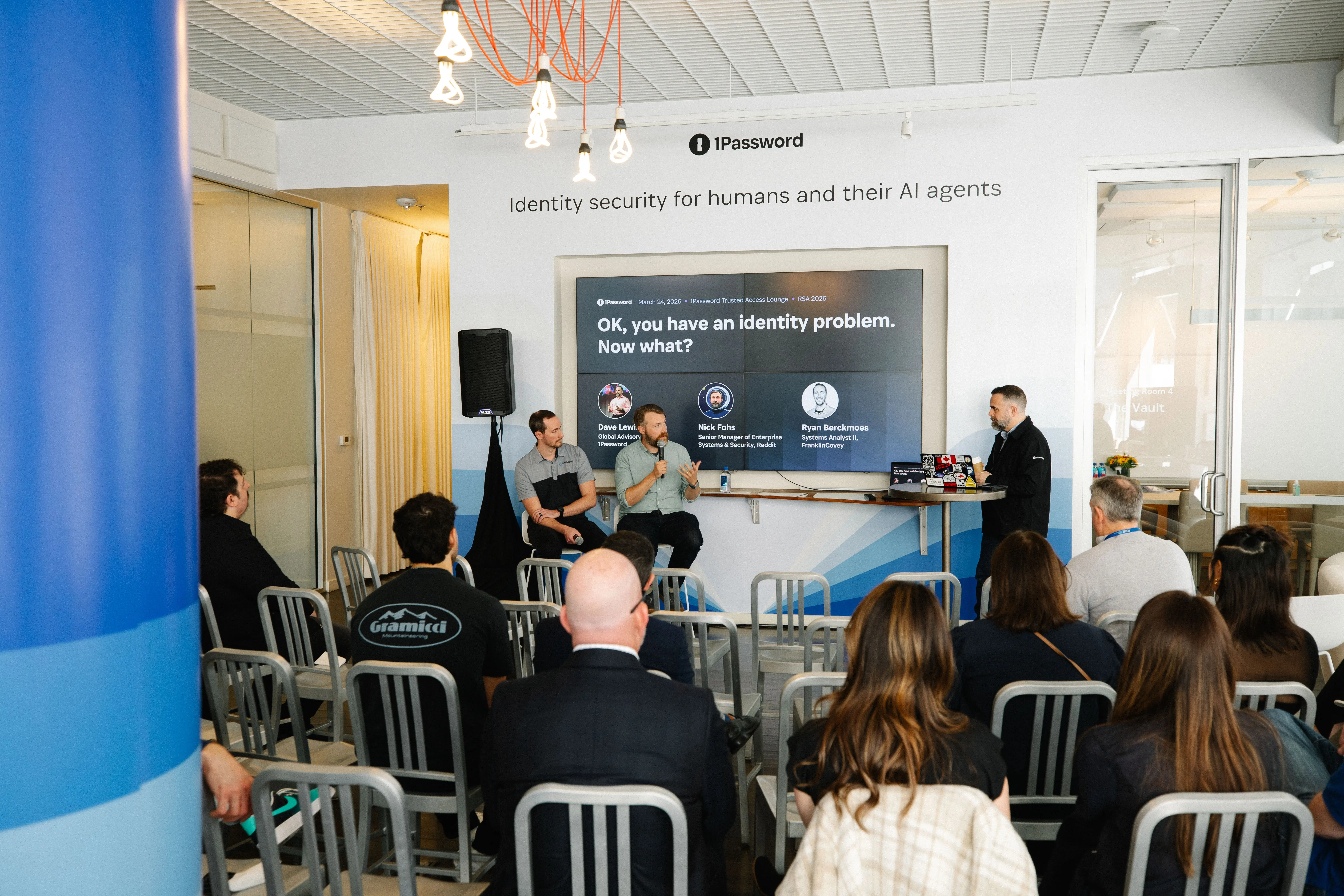 Dave Lewis and two panelists addressing a room of RSA attendees