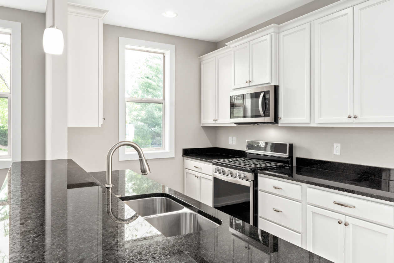 This clean bright kitchen with neutral tones is waiting for a splash of color.