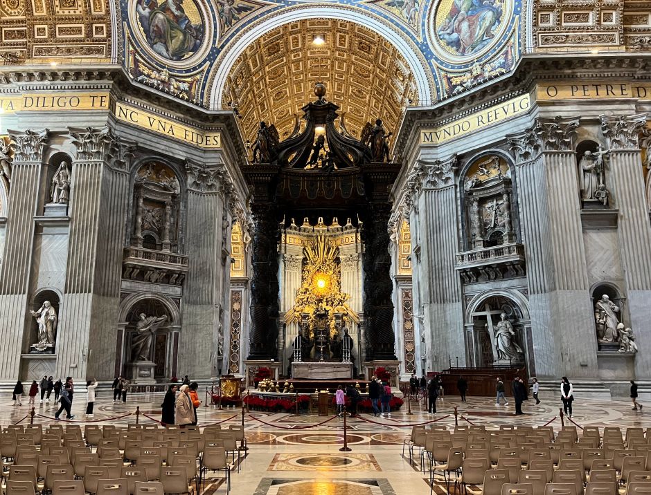 Bernini's enormous bronze baldachin is strategically positioned: it draws the eye to the dome above it, to Saint Peter's tomb below it, and to the Papal throne seen through it. Photo: Tas Tóbiás