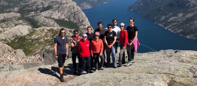 Content Services team from Making Waves Poland during their trip to Norway. Mountains and a lake in the background. 