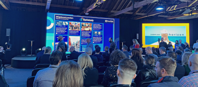 Opticon conference in London – two large screens and participants.