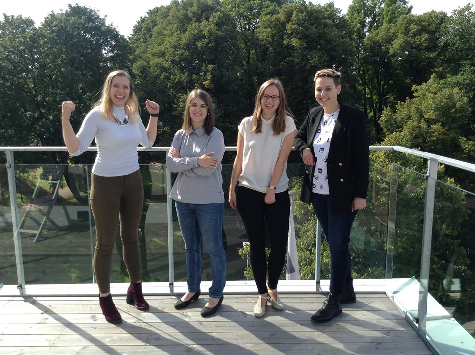 Four girls from the internship program in NoA Ignite stand on the balcony