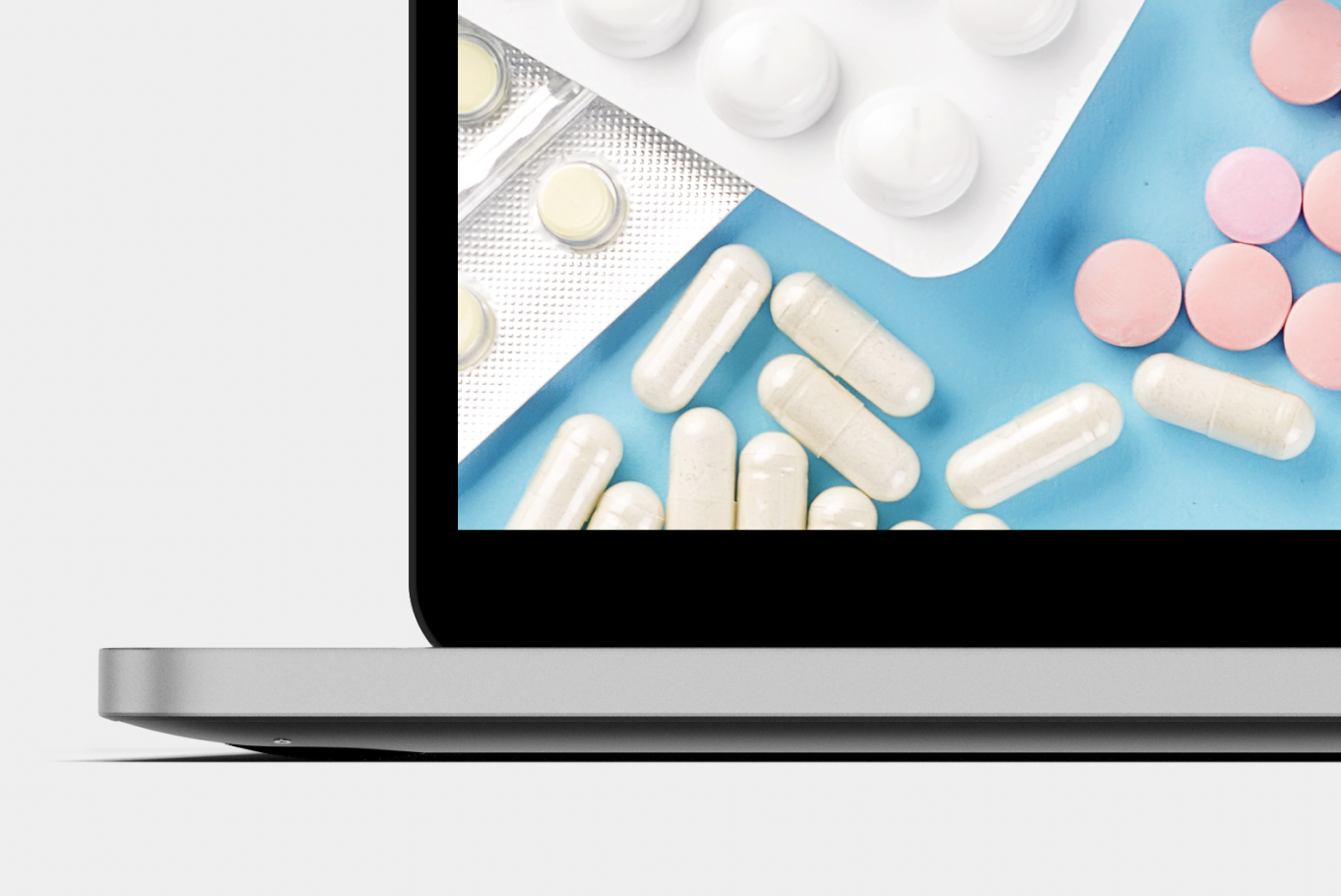 Piece of a laptop with medicines on the screen. 