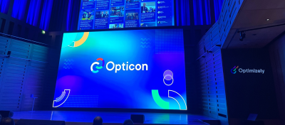 A stage with a large screen from the Opticon conference.