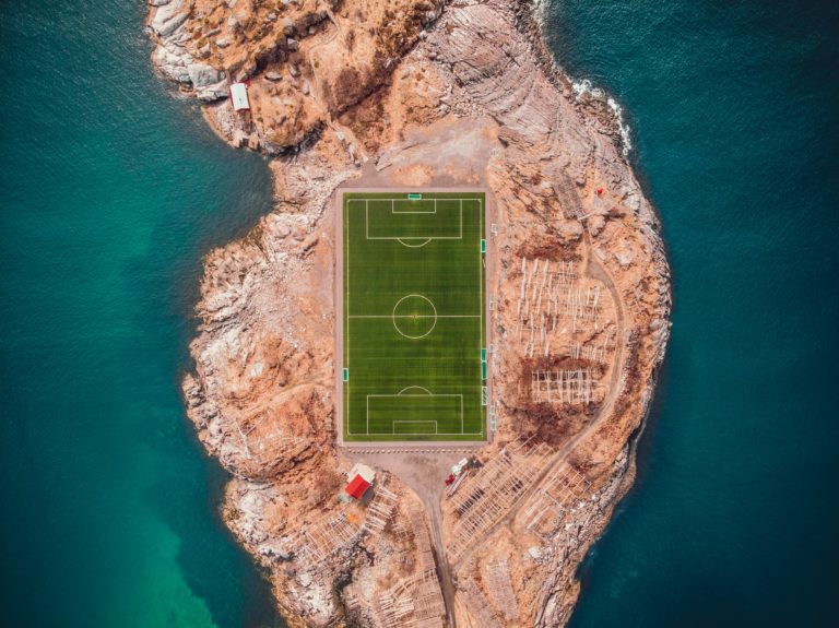 Aerial view of a football pitch placed on an island.