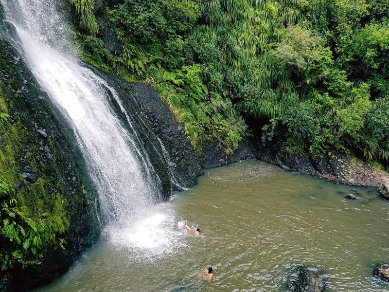 Black Sand Adventures takes you swimming under a waterfall at Kitekite falls