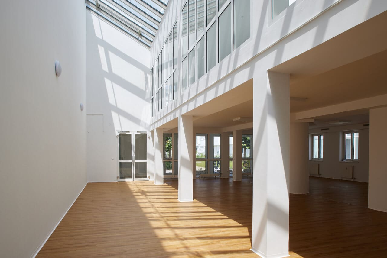 A room with many windows and a wooden floor