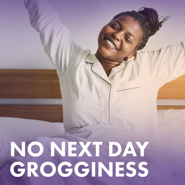 Person stretching in bed wearing pajamas with text stating "No next day grogginess".