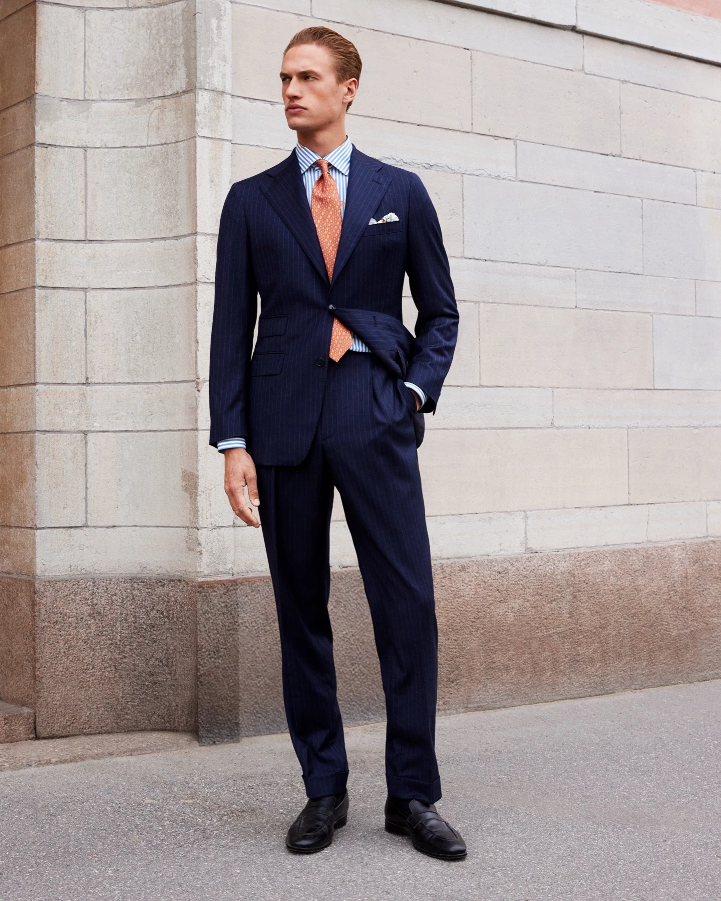 model in suit blue shirt and orange tie city environment