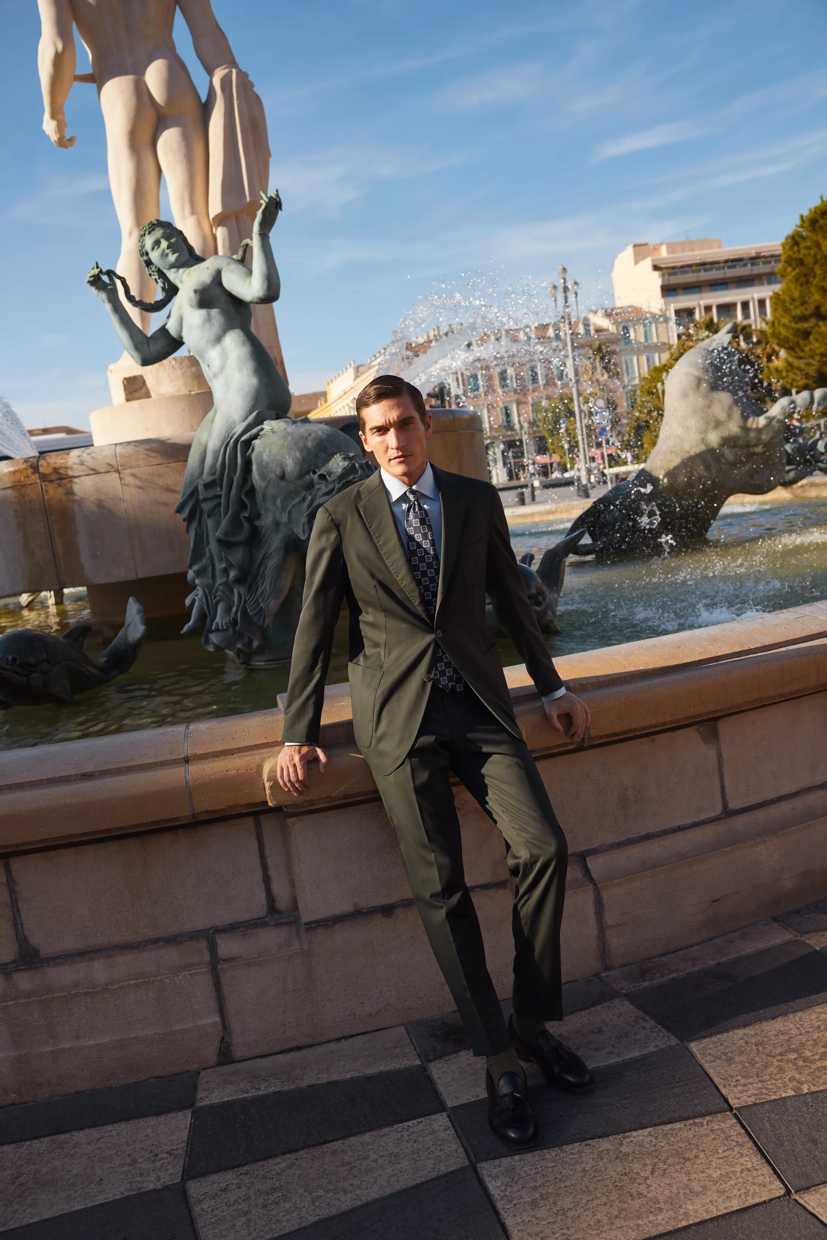 model in green shirt suit and tie