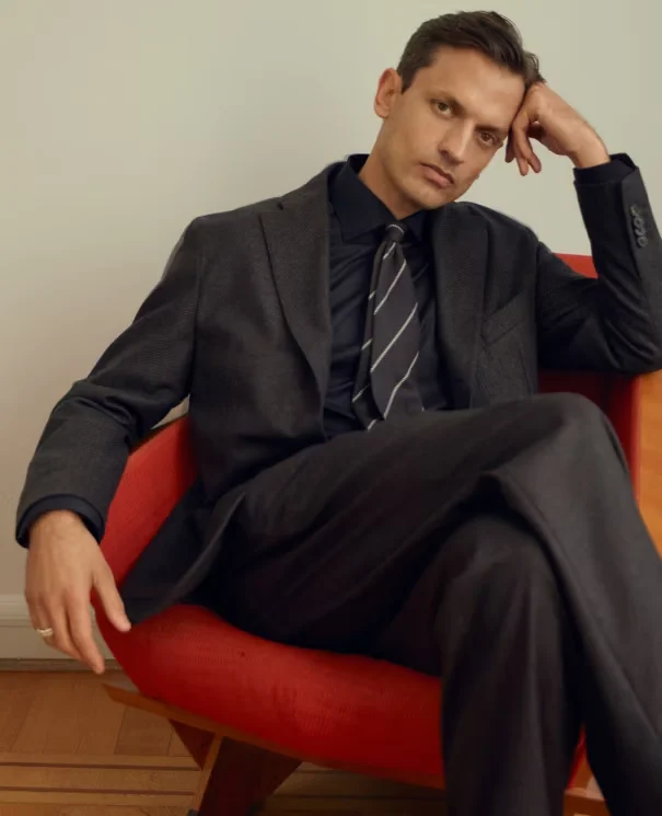 a man posing in a orange armchair