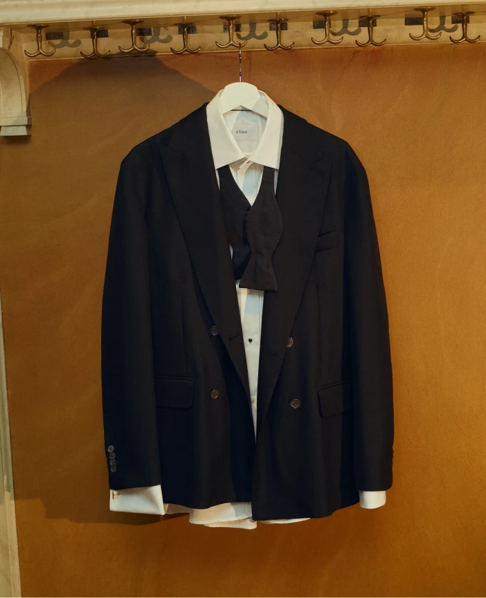 a tuxedo outfit hanging on a hanger