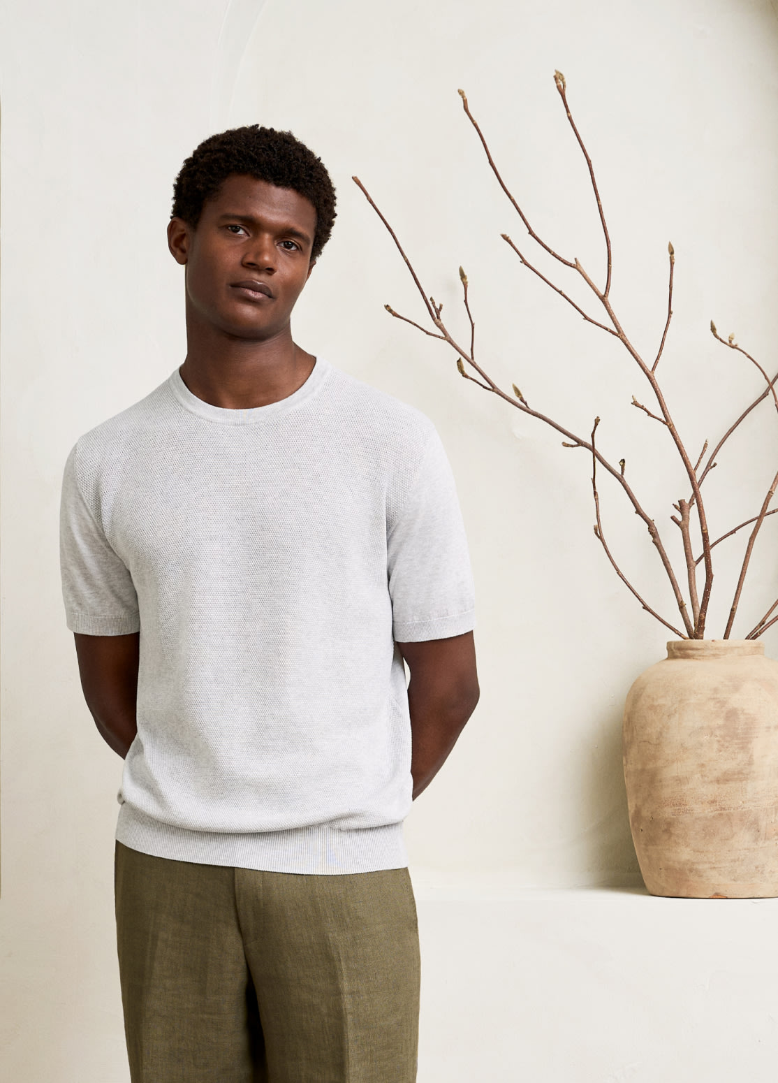 model in off white knitted t-shirt