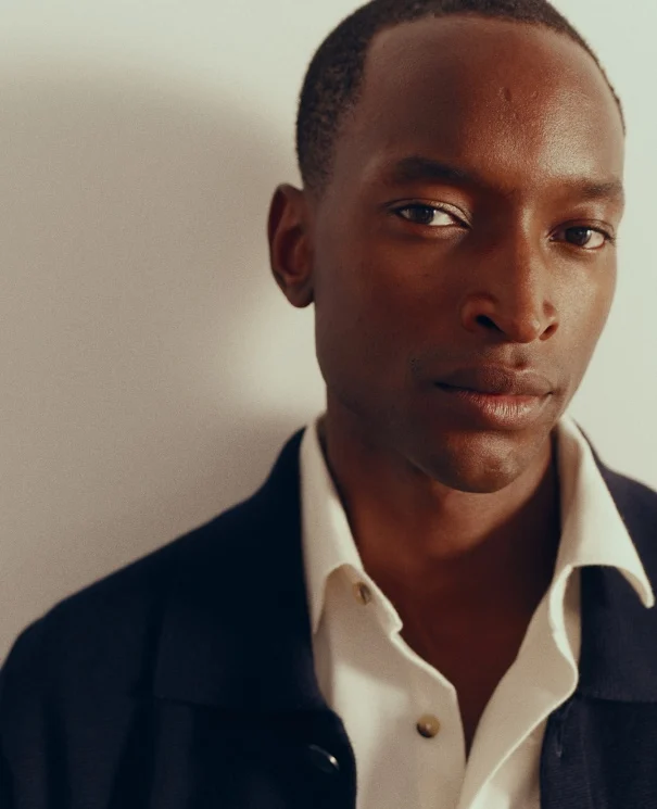 a model close up in a flannel shirt and a overshirt