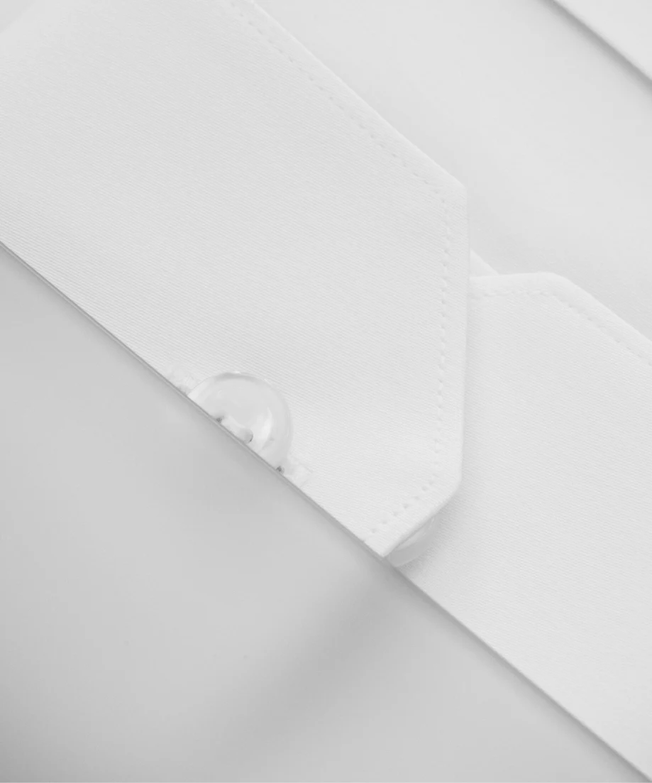 a close up of a mother of pearl button of a cuff