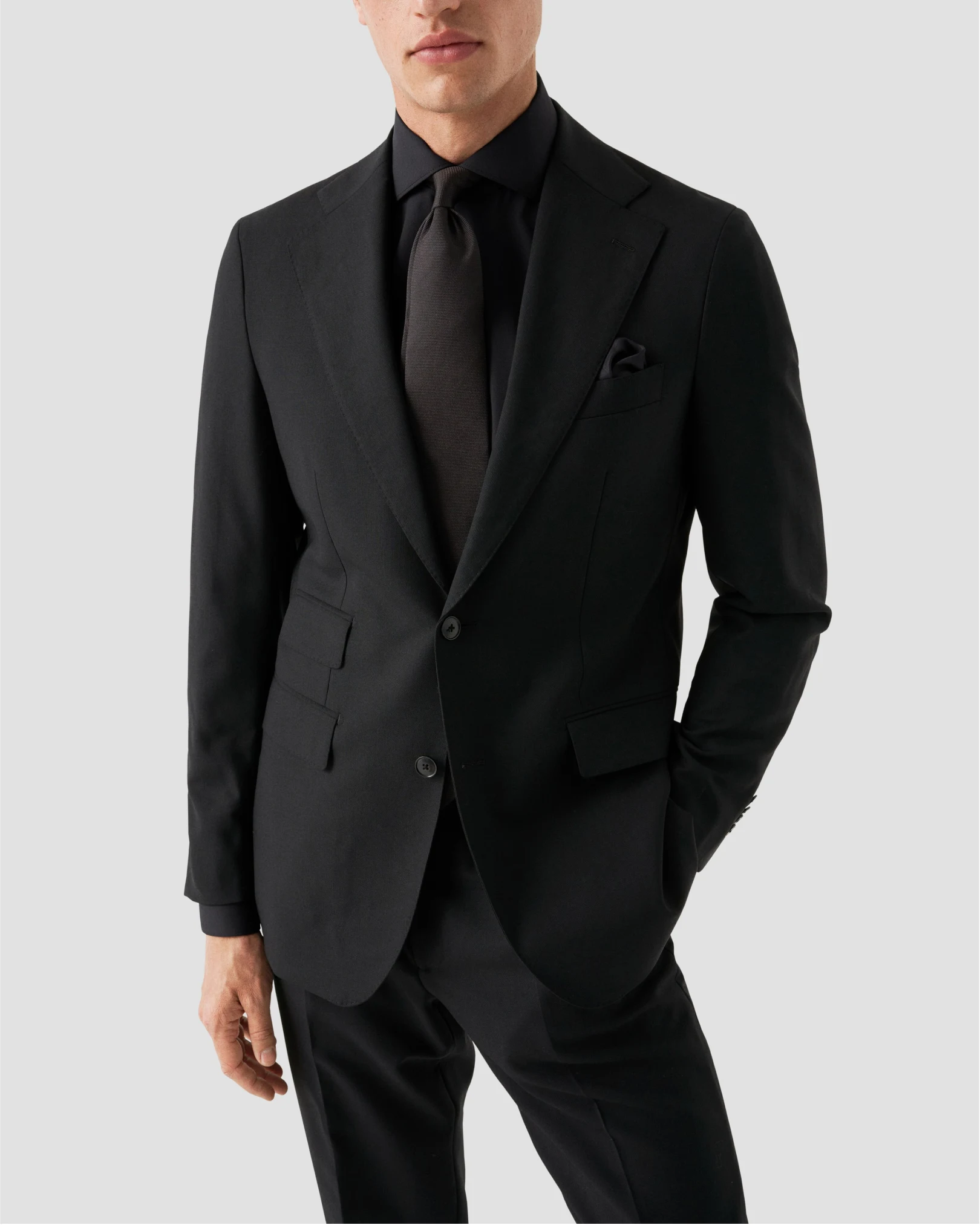 model dressed in black shirt and suit