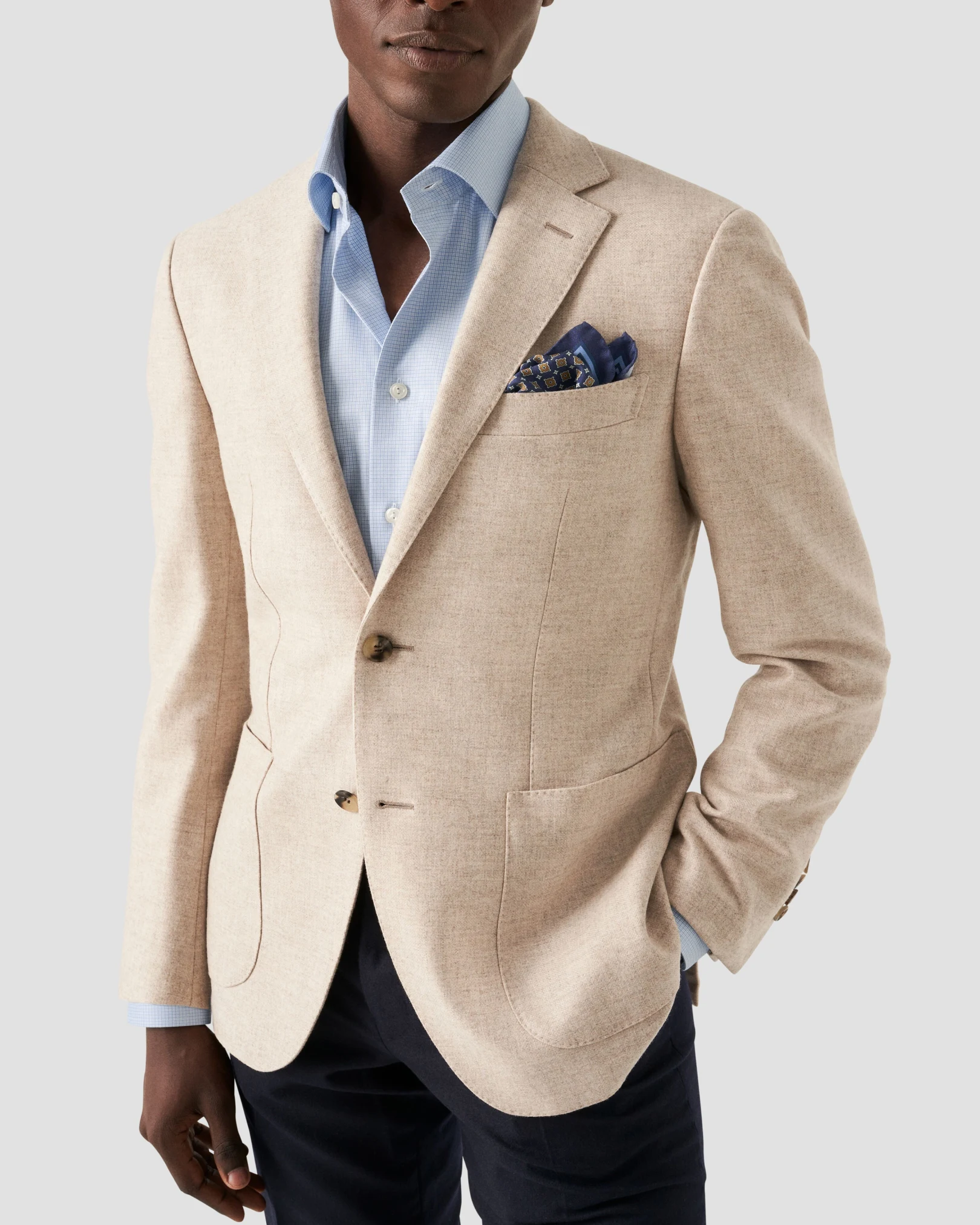 model in beige suit and lightblue microprint shirt