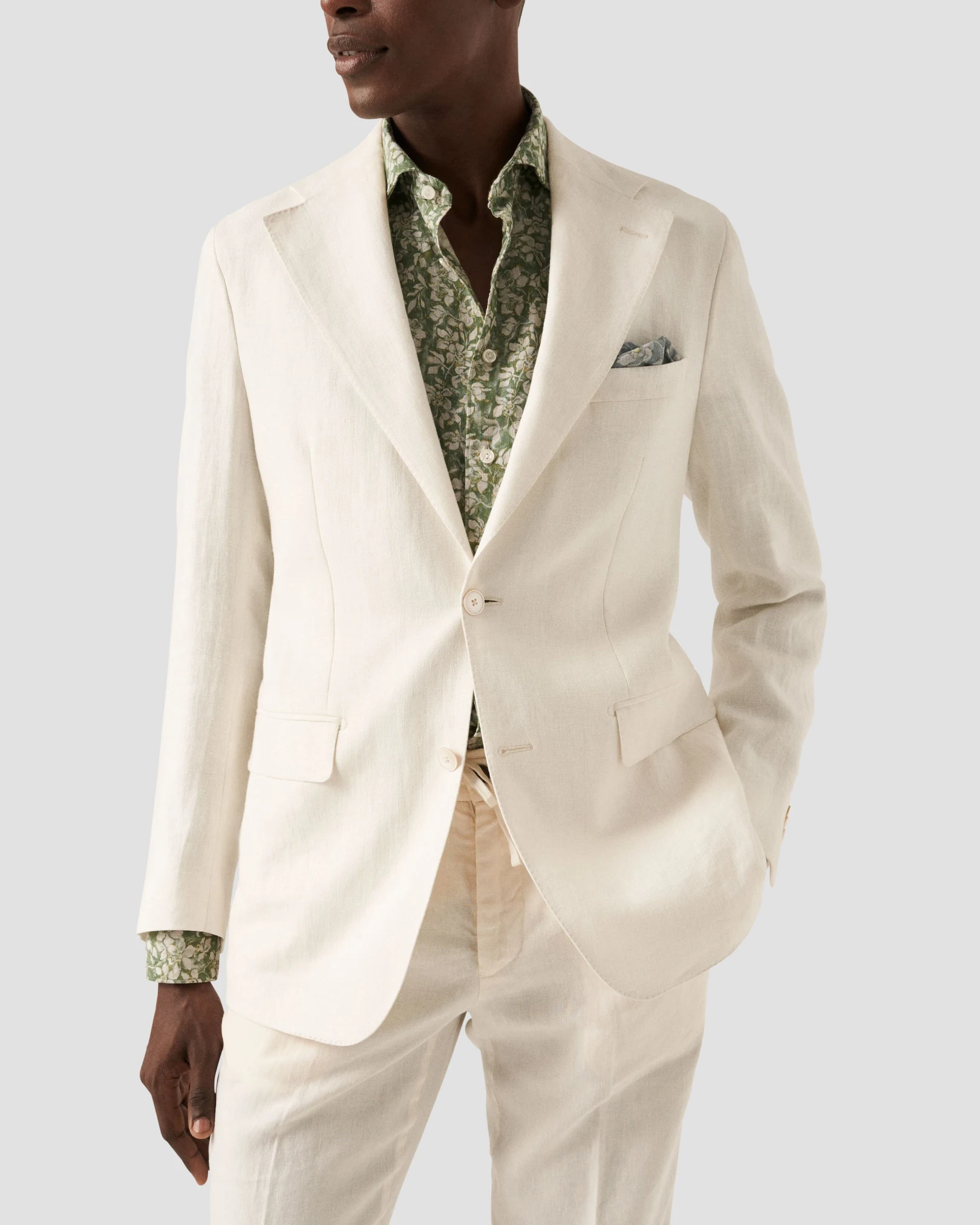 green floral shirt styled with beige suit