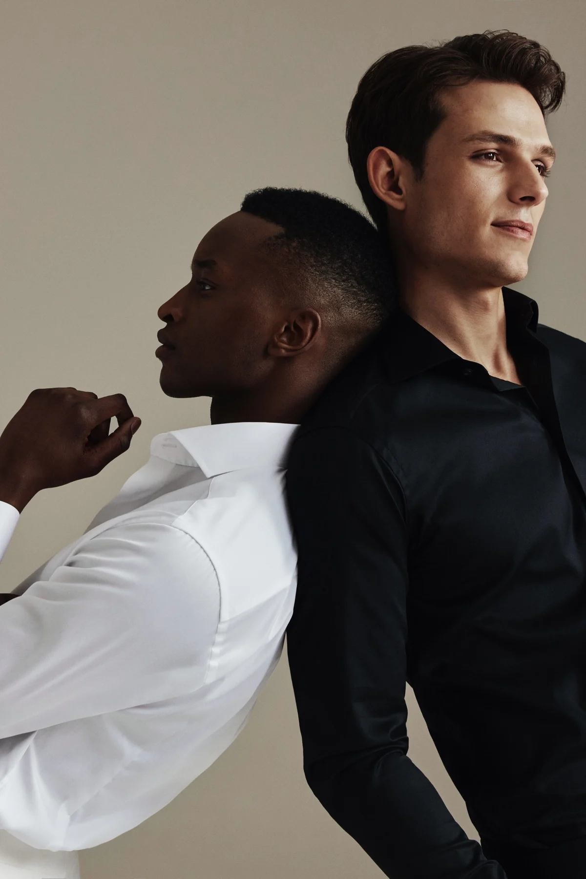 two men dressed in white signature twill shirt and black signature twill shirt