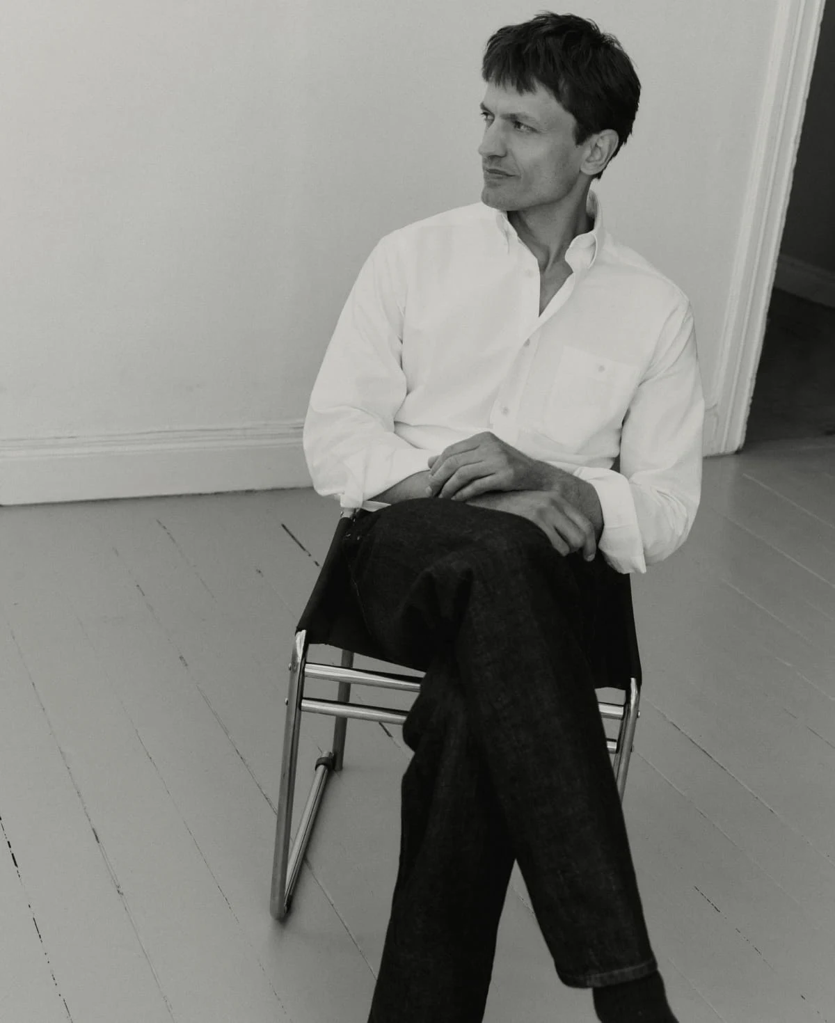 man sitting on a chair in eton oxford shirt