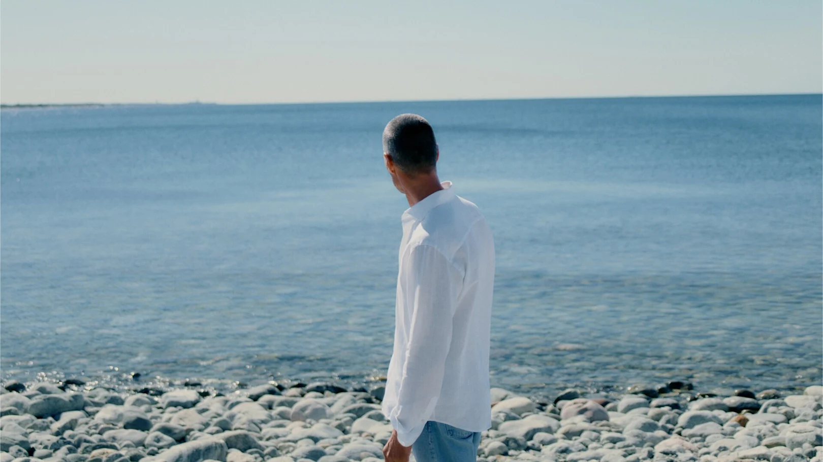 A model in a linen shirt posing