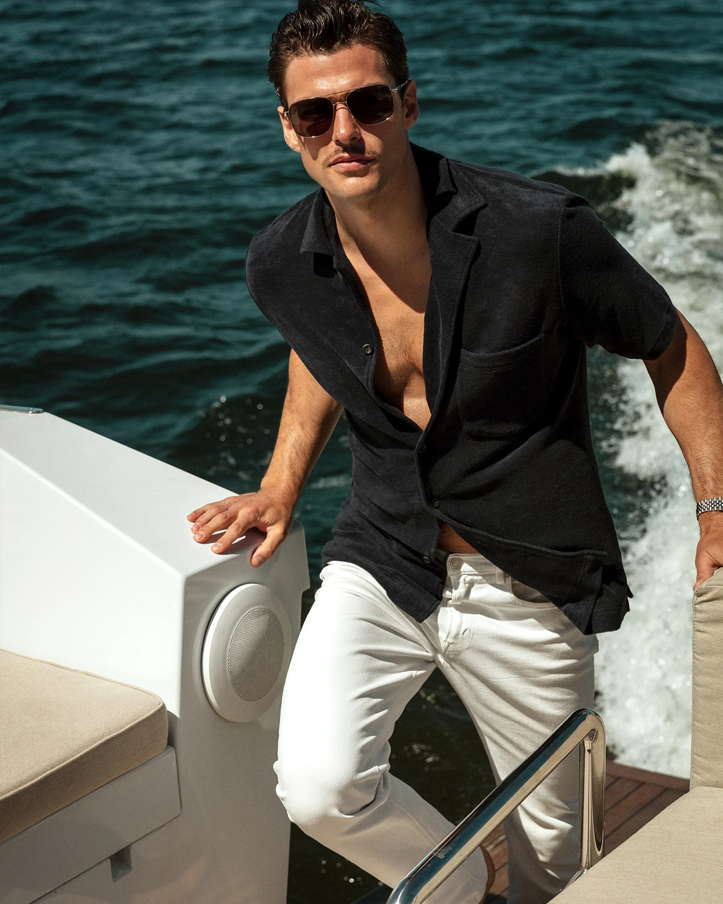 A man wearing an Eton terry resort shirt with a pair of white jeans