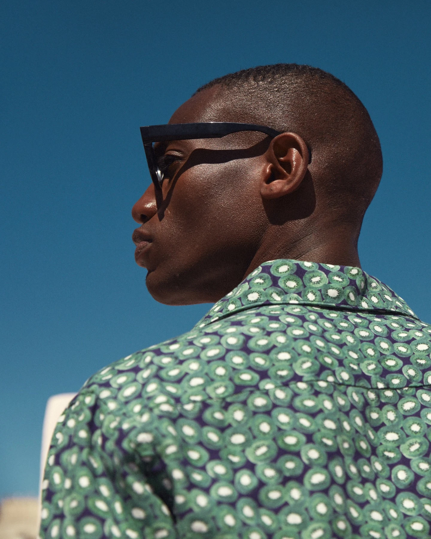 model in kiwi print shirt