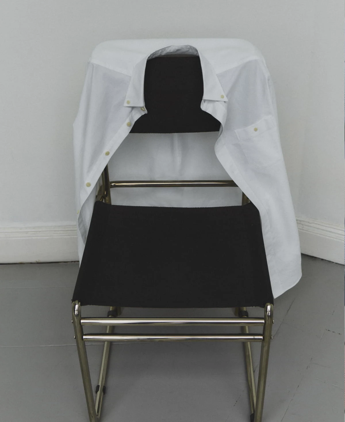 white eton oxford shirt hanging on a chair