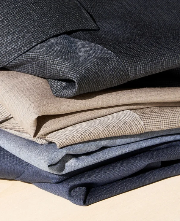 a pile of merino shirts in different colors