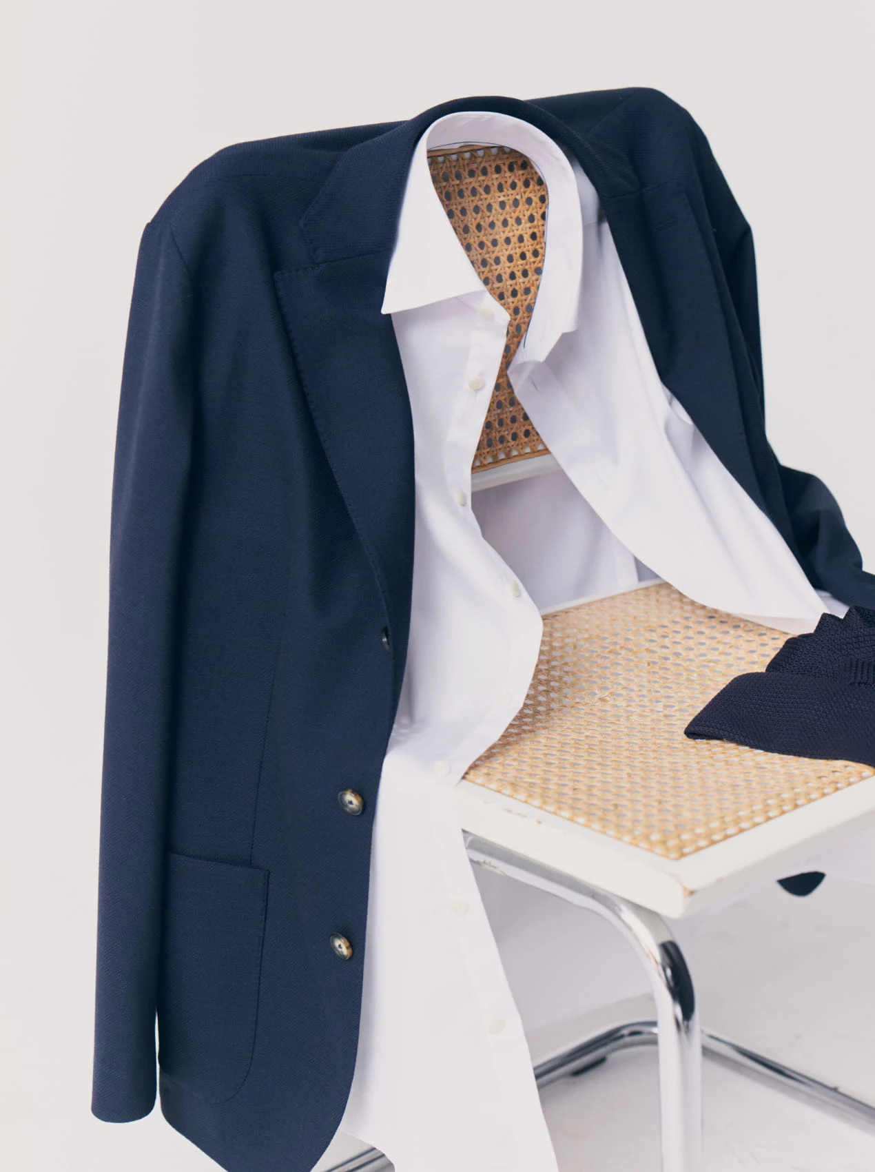 soft jacket and a white dress shirt hanging on a chair