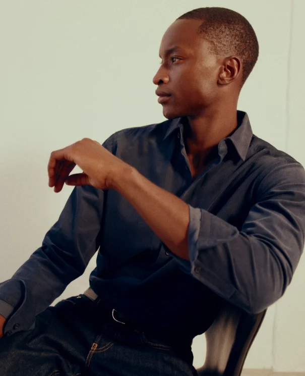 a model posing in a dark corduroy shirt