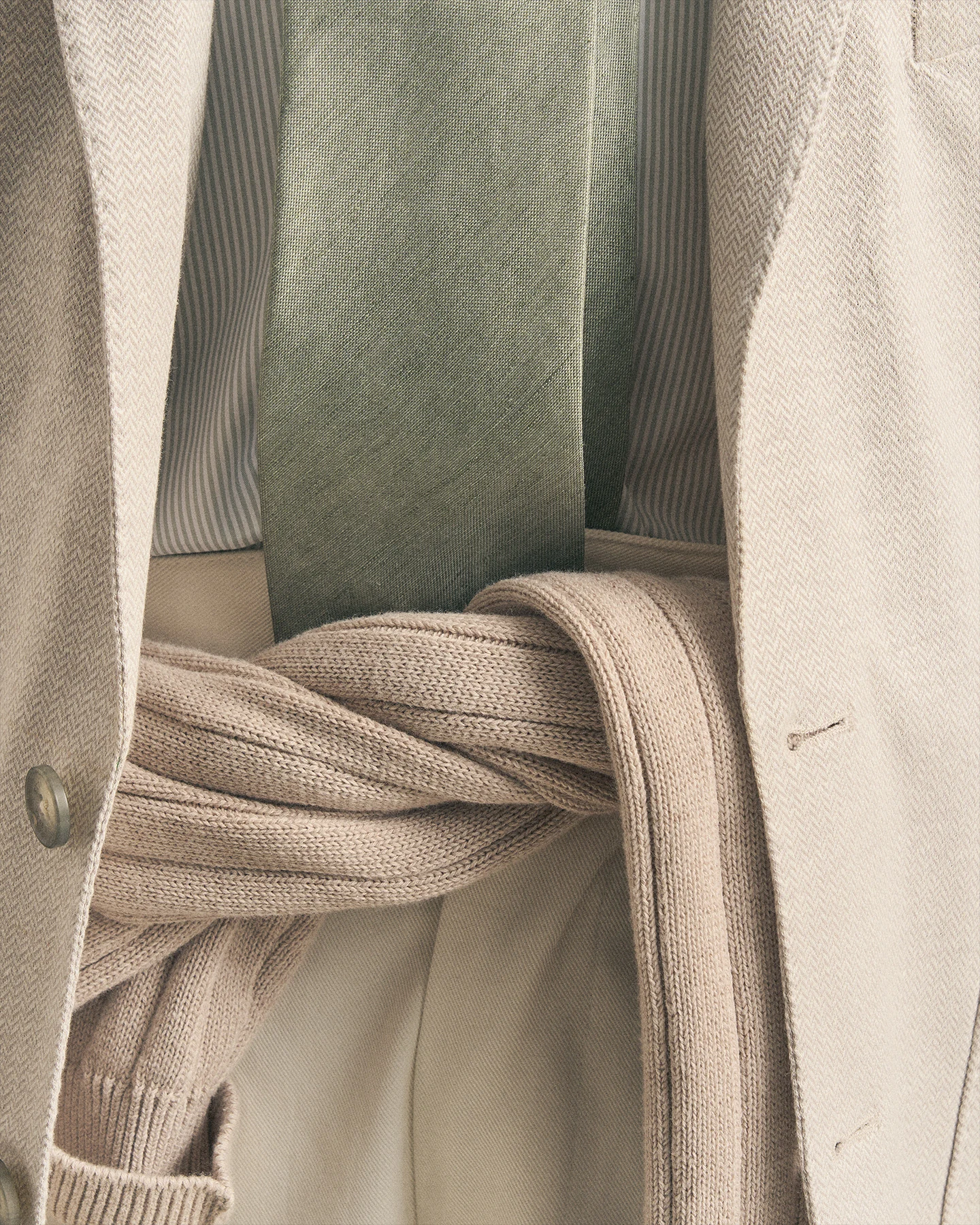 beige blazer with green tie