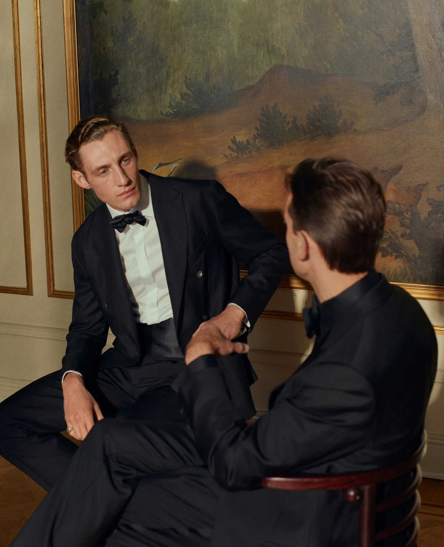 two gentlemen engaging in conversation in old renaissance room