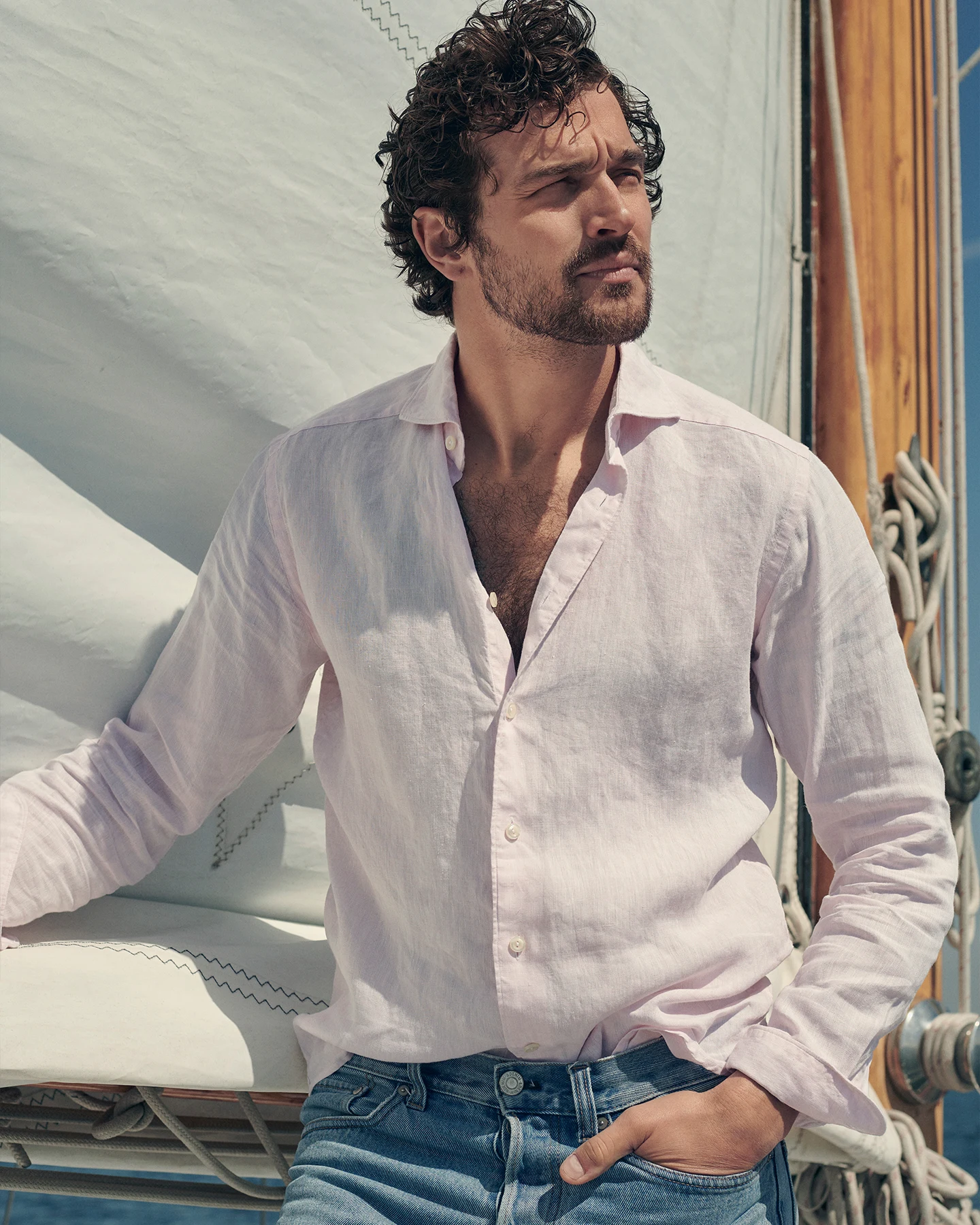 Man on a boat wearing a pink linen shirt