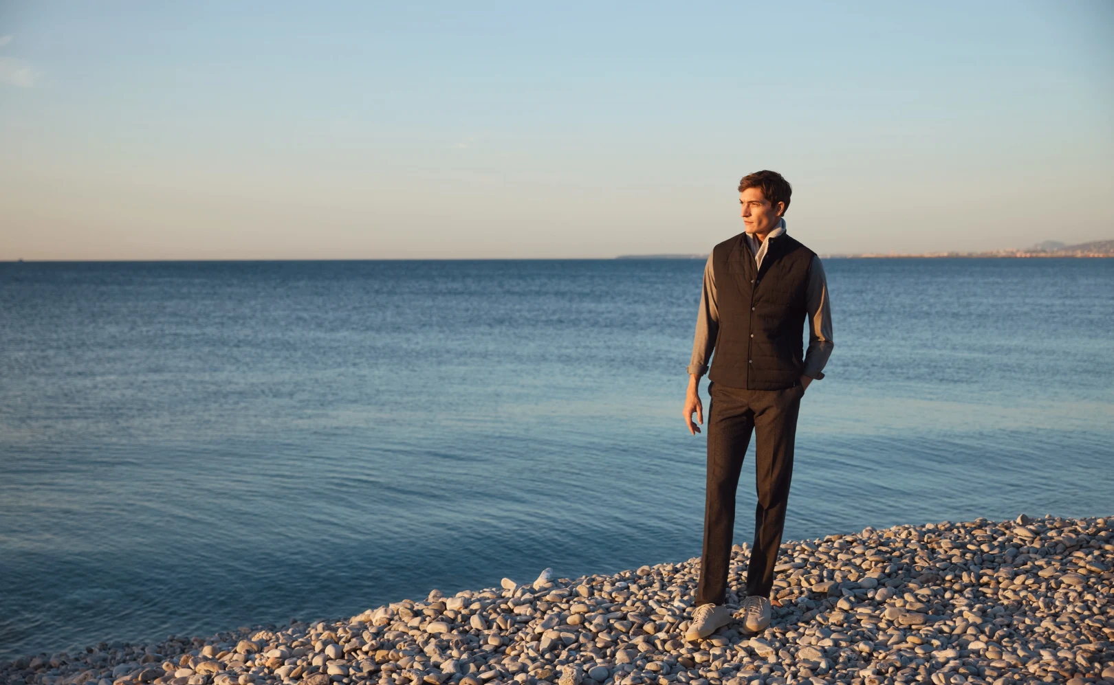 model in vest at beach