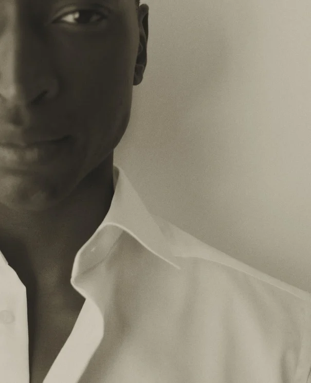 a model in black and white posing in a white signature twill shirt