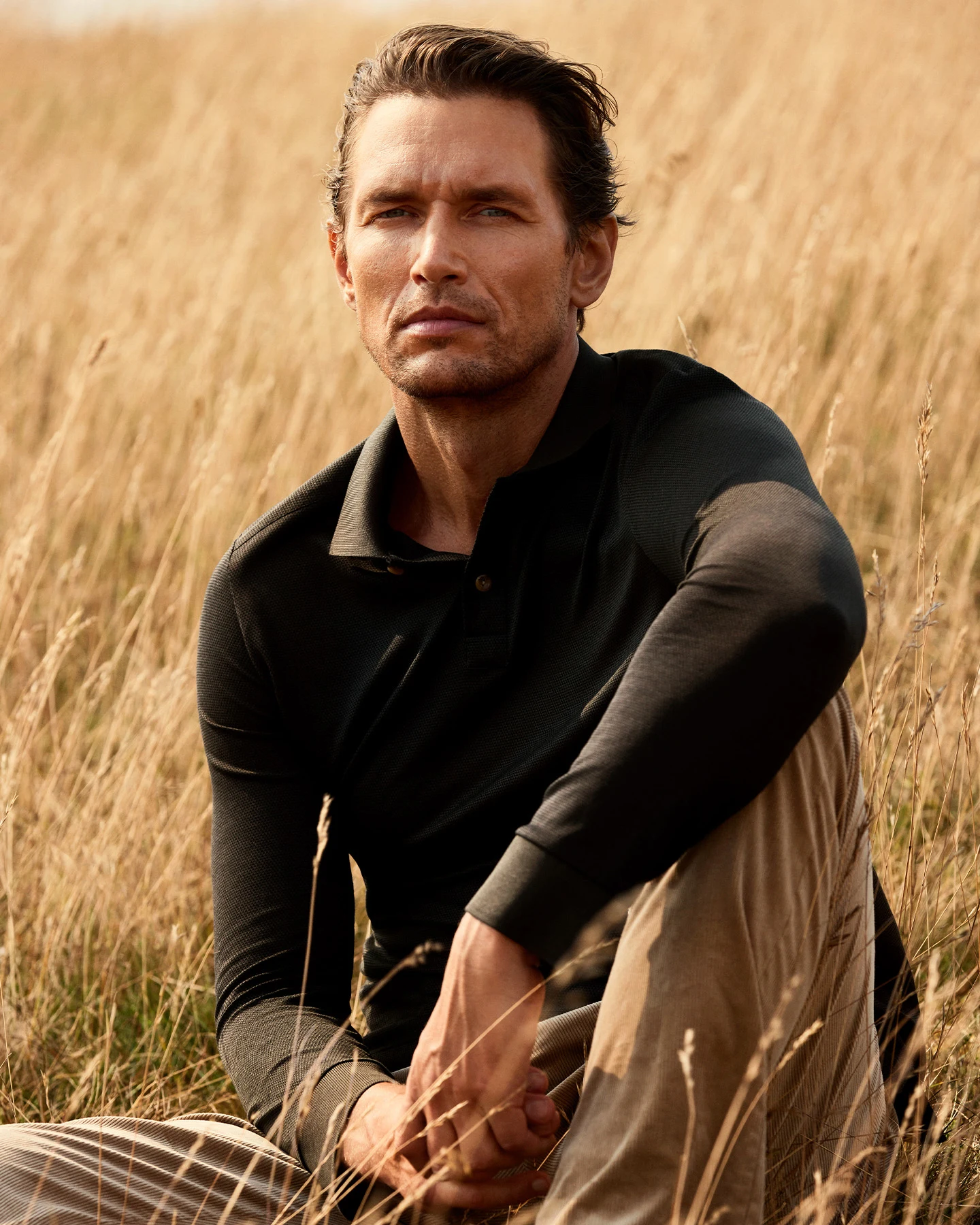 model sitting with polo shirt