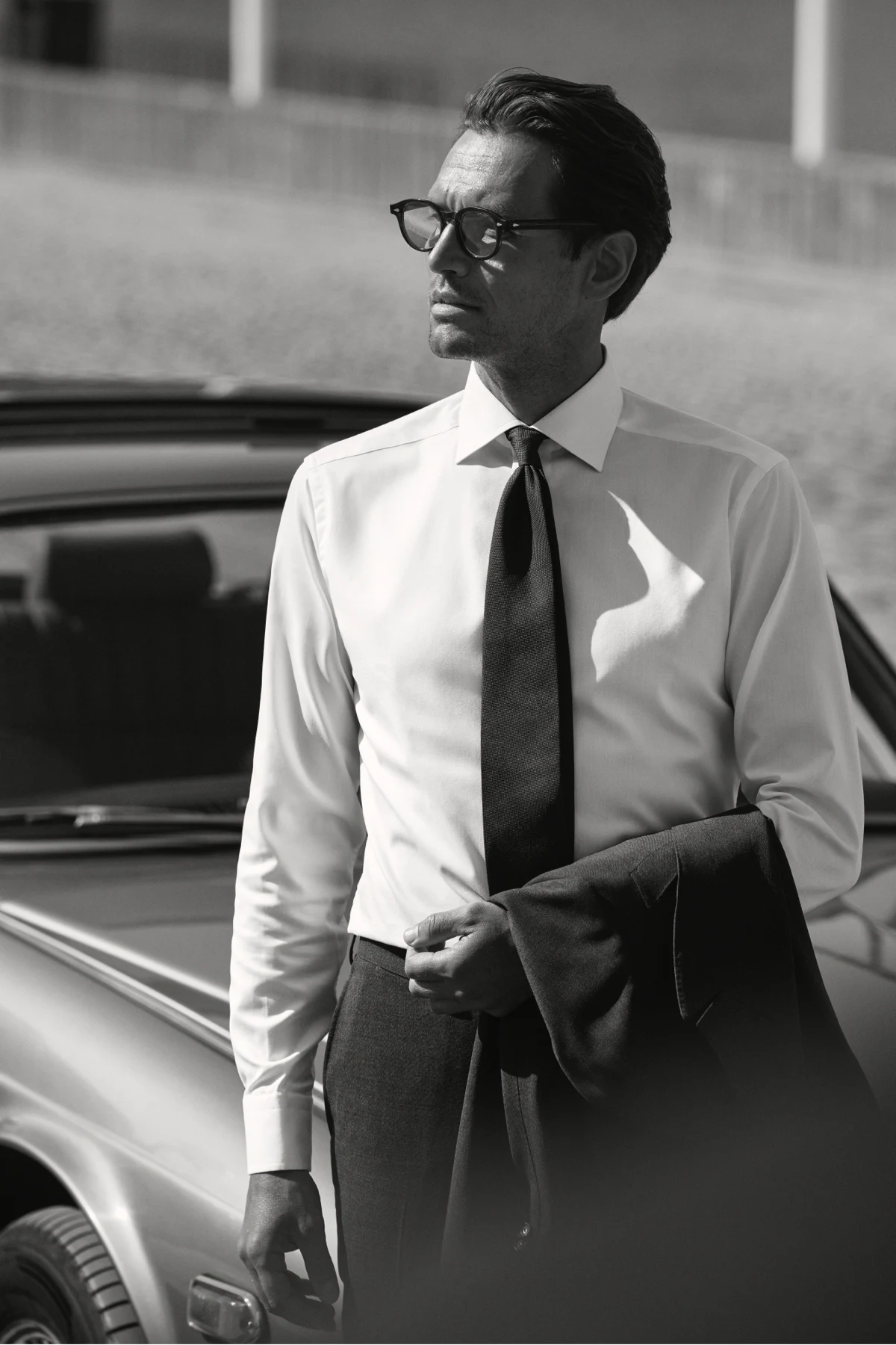 white shirt styled on model leaning on car