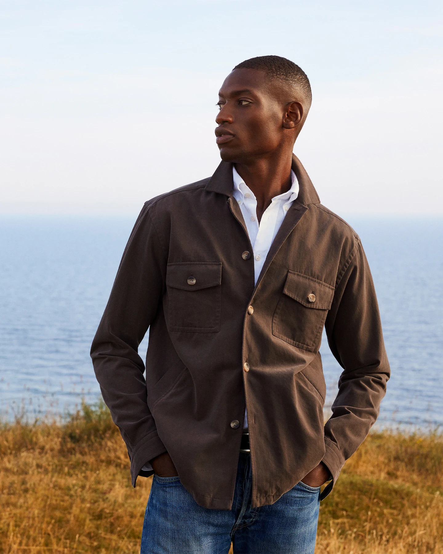 model in white shirt and brown overshirt