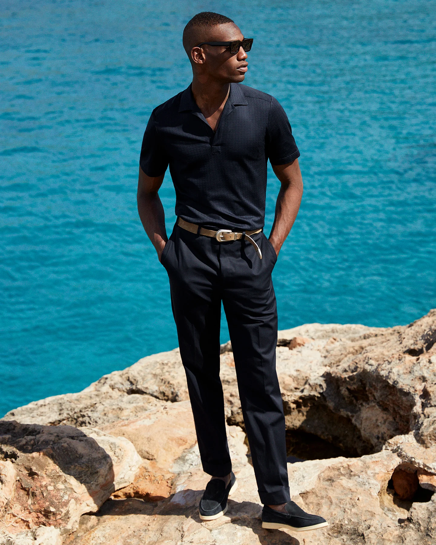 model with navy polo shirt and chinos at beach