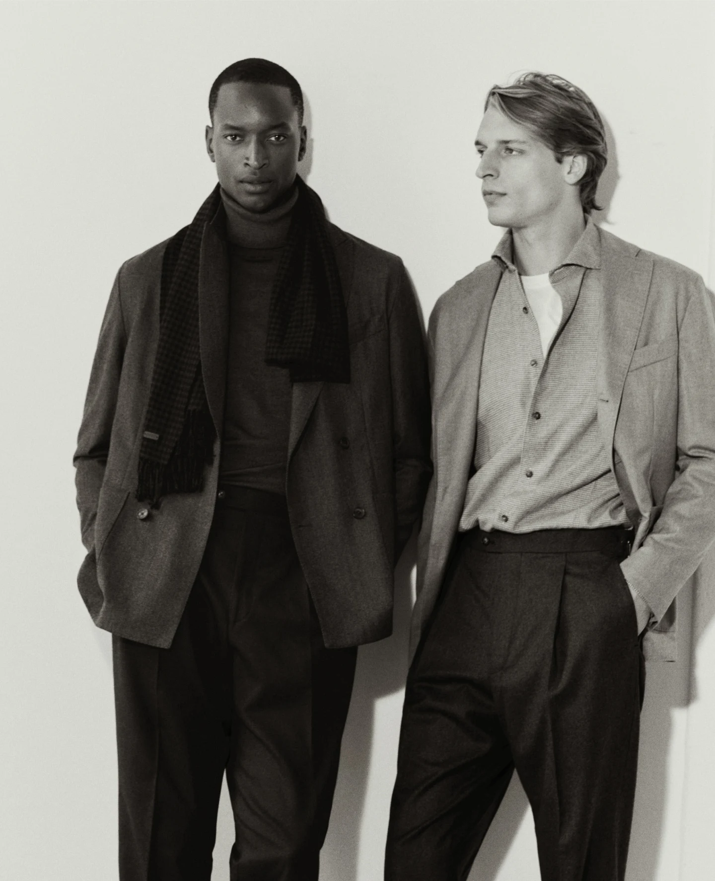 Two models posing in black and white in Eton's AW26 collection